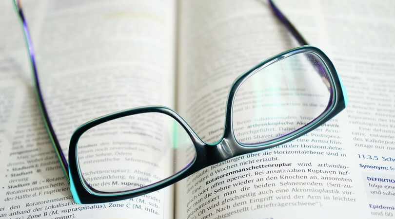 Eyeglasses sitting on an open book